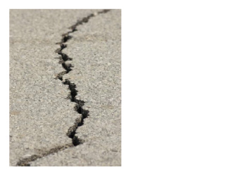 Photo of a sidewalk with a ragged crack down the center