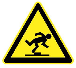 Sign shaped like a triangle with a stickman tripping on an obstacle on the ground