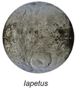The image depicts Iapetus, one of Saturn's moons. It is a nearly spherical celestial body with a prominent contrast in surface coloration. The left side of the moon appears brighter with shades of gray and white, indicative of icy regions. The right side is darker with deep, almost black areas, suggesting a surface coated in a different material, possibly dust or rock. Distinct craters and surface textures are visible, adding to the rugged appearance of the moon. The complexity of terrains spreads across the surface, with varying levels of brightness and shadow indicating topographical features like ridges and depressions.