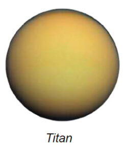 The image presents Saturn's moon, Titan, depicted as a large, spherical object dominating the frame. The surface of Titan appears smooth with a predominantly orange hue, transitioning into subtle shades of yellow and brown. The edges of Titan are slightly darker, creating a vignette effect, contributing to a sense of dimension and depth.