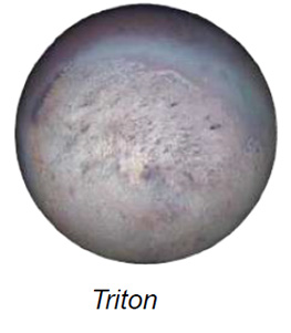 The image depicts Neptune's moon Triton, showing a spherical celestial body with a textured surface. The predominant color is a muted, dusty beige with variations of light and dark patches across the surface, suggesting craters or geological formations. The moon is slightly illuminated, with subtle shadowing that accentuates its topography. A faint blue hue encircles the upper portion, contributing to a slightly ethereal appearance.